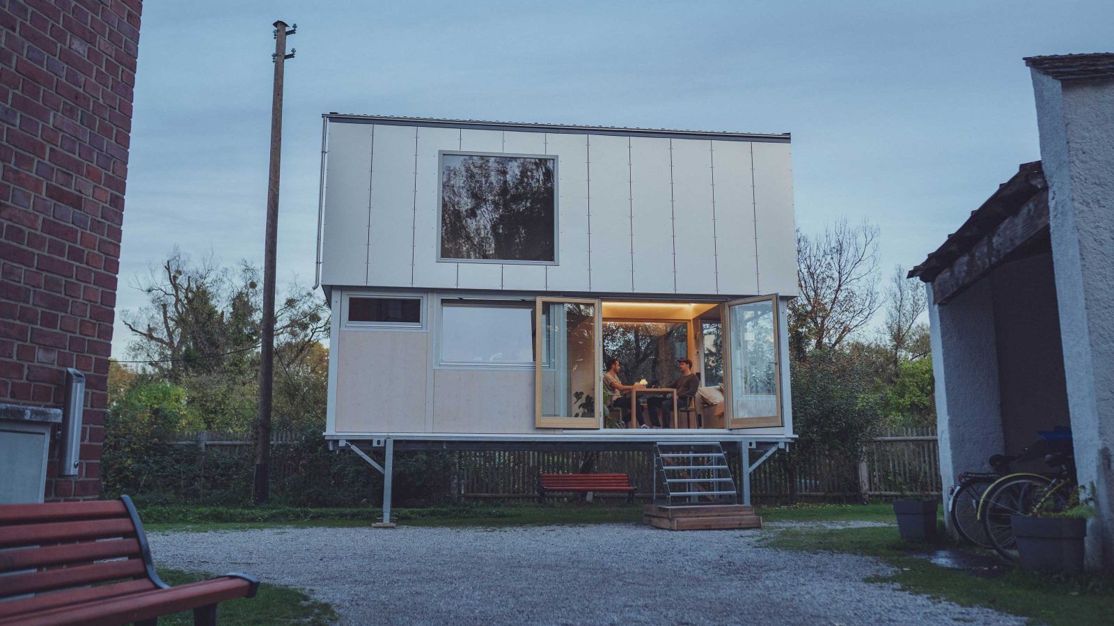 Im Musterhaus «#vagabundoflex» entsteht mit offenem Design und kompakter Raumgestaltung ein grosszügiges Wohngefühl. Dank eines versteckten Hubsystems lässt sich das Tiny House auf eine Ebene zusammenschieben und mit einem LKW an einen anderen Standort versetzen.